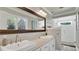 Elegant bathroom featuring double sinks, a large mirror, and a white tile shower at 623 Tuskawilla Point Ln, Winter Springs, FL 32708