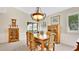 Bright dining room with classic wooden furniture and a view to the outdoor space at 623 Tuskawilla Point Ln, Winter Springs, FL 32708