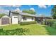 Home exterior featuring a well-maintained lawn, storage shed, and a screened-in patio for outdoor enjoyment at 623 Tuskawilla Point Ln, Winter Springs, FL 32708