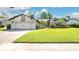 Charming single-story home with lush green lawn, manicured landscaping, and brick driveway at 623 Tuskawilla Point Ln, Winter Springs, FL 32708