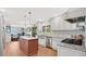 Open kitchen with stainless steel appliances, a center island, and wood floors at 623 Tuskawilla Point Ln, Winter Springs, FL 32708