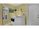 Functional laundry room featuring modern washer and dryer units, with a window providing natural light at 623 Tuskawilla Point Ln, Winter Springs, FL 32708