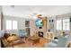 Cozy living room featuring a stone fireplace, built-in shelving, and wood flooring at 623 Tuskawilla Point Ln, Winter Springs, FL 32708