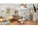 Comfortable living room featuring a ceiling fan, wood floors, and a brown leather couch at 623 Tuskawilla Point Ln, Winter Springs, FL 32708