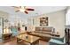 Inviting living room with a ceiling fan, wood floors, and an open view to the kitchen at 623 Tuskawilla Point Ln, Winter Springs, FL 32708
