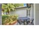 Outdoor patio features a table, chairs, and a view of the manicured landscaping at 623 Tuskawilla Point Ln, Winter Springs, FL 32708