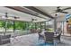 Spacious screened patio with brick flooring and ceiling fans, offering an ideal space for outdoor dining and entertaining at 623 Tuskawilla Point Ln, Winter Springs, FL 32708