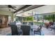 Inviting screened patio with stone floors and an outdoor dining set perfect for relaxing and enjoying the serene outdoor view at 623 Tuskawilla Point Ln, Winter Springs, FL 32708