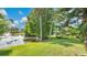 Scenic view of a pond surrounded by lush greenery and mature trees at 623 Tuskawilla Point Ln, Winter Springs, FL 32708