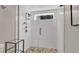 Modern shower showcasing sleek design, white tile walls, and a stone pebble floor at 623 Tuskawilla Point Ln, Winter Springs, FL 32708