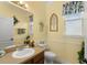 Bathroom with vanity sink and mirror, toilet, and decorative wall hangings at 7003 Cupseed Ln, Harmony, FL 34773