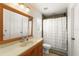 Cozy bathroom with vanity, mirror, and shower with a white curtain, designed for comfort at 7003 Cupseed Ln, Harmony, FL 34773