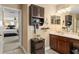 Bathroom featuring a vanity with a white countertop, wood cabinets, and a decorative mirror at 7003 Cupseed Ln, Harmony, FL 34773