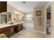 Bright bathroom with double vanity, soaking tub, tile floor, and neutral color scheme at 7003 Cupseed Ln, Harmony, FL 34773