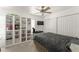 Serene bedroom featuring a large bed, built-in shelves, closet and ceiling fan, perfect for resting at 7003 Cupseed Ln, Harmony, FL 34773