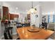 Dining area with view of the kitchen, featuring wood table and barstool seating at 7003 Cupseed Ln, Harmony, FL 34773