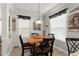 Cozy dining room with wood table and chairs and natural light at 7003 Cupseed Ln, Harmony, FL 34773