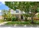 Charming home with a covered porch and an American flag at 7003 Cupseed Ln, Harmony, FL 34773
