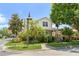 Landscaped corner lot with a charming two-story home, surrounded by lush greenery and mature trees at 7003 Cupseed Ln, Harmony, FL 34773