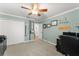 Functional home office with a closet, desk setup, and a calming color scheme at 7003 Cupseed Ln, Harmony, FL 34773