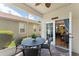 Relax on the screened patio with a ceiling fan and door leading into the home at 7003 Cupseed Ln, Harmony, FL 34773