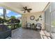 The screened patio features comfortable seating and a ceiling fan at 7003 Cupseed Ln, Harmony, FL 34773