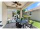 Relax on the screened patio featuring a ceiling fan and brick flooring at 7003 Cupseed Ln, Harmony, FL 34773