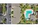 Aerial view of a community pool, parking area, lush landscaping, and well-maintained condo buildings at 758 E Michigan St # 203, Orlando, FL 32806