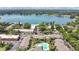 Aerial view of condos near a large lake, showcasing lush trees, parking, and water access for residents at 758 E Michigan St # 203, Orlando, FL 32806
