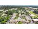 Aerial view of condos featuring lush trees, a swimming pool, and convenient parking spaces in the community at 758 E Michigan St # 203, Orlando, FL 32806