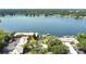 Panoramic aerial view of lakefront condos featuring a community pool, lush greenery, and a private dock at 758 E Michigan St # 203, Orlando, FL 32806