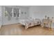 Bright bedroom featuring modern flooring, neutral walls, and a queen-sized bed at 758 E Michigan St # 203, Orlando, FL 32806
