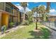Exterior view of condominium buildings surrounding community pool and tropical landscaping at 758 E Michigan St # 203, Orlando, FL 32806