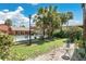 Backyard view of a community pool and clubhouse amid lush landscaping and palm trees at 758 E Michigan St # 203, Orlando, FL 32806
