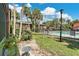 Backyard view of a community pool surrounded by tropical landscaping and multi-story buildings at 758 E Michigan St # 203, Orlando, FL 32806