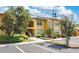 Inviting two-story condo featuring manicured landscaping, a covered entryway, and convenient parking at 758 E Michigan St # 203, Orlando, FL 32806