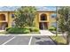 Well-maintained two-story condo with neat landscaping, a paved walkway, and designated parking spaces at 758 E Michigan St # 203, Orlando, FL 32806