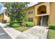 Inviting two-story condo featuring well-maintained landscaping and a charming arched entryway at 758 E Michigan St # 203, Orlando, FL 32806