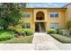 Inviting two-story condo featuring well-maintained landscaping and a charming arched entryway at 758 E Michigan St # 203, Orlando, FL 32806