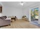 Bright living room with modern flooring, neutral walls, and access to the outdoor patio at 758 E Michigan St # 203, Orlando, FL 32806
