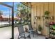 Screened patio with outdoor seating and garden decor offering views of tropical landscaping at 758 E Michigan St # 203, Orlando, FL 32806