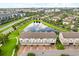 Aerial view highlighting modern townhomes surrounding a tranquil lake and green spaces at 7724 Sweet Star Ave, Orlando, FL 32836