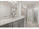 Bathroom featuring double sinks with quartz countertops, a shower, and a separate toilet room at 7724 Sweet Star Ave, Orlando, FL 32836