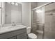 Modern bathroom with glass shower, white marble countertop, and gray vanity at 7724 Sweet Star Ave, Orlando, FL 32836