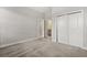 Bedroom featuring neutral carpet, trim, an ensuite, and double closet at 7724 Sweet Star Ave, Orlando, FL 32836