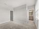 Bedroom with neutral carpet shows the doorway to the bathroom and second doorway at 7724 Sweet Star Ave, Orlando, FL 32836