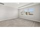 A spacious bedroom with plush carpeting and three windows offering natural light at 7724 Sweet Star Ave, Orlando, FL 32836