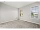 Bright bedroom with carpet and two windows providing natural light at 7724 Sweet Star Ave, Orlando, FL 32836