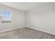 This bedroom has neutral carpet, and a window overlooking the neighborhood at 7724 Sweet Star Ave, Orlando, FL 32836