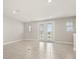 Light-filled bonus room featuring tiled flooring and French doors to a balcony at 7724 Sweet Star Ave, Orlando, FL 32836